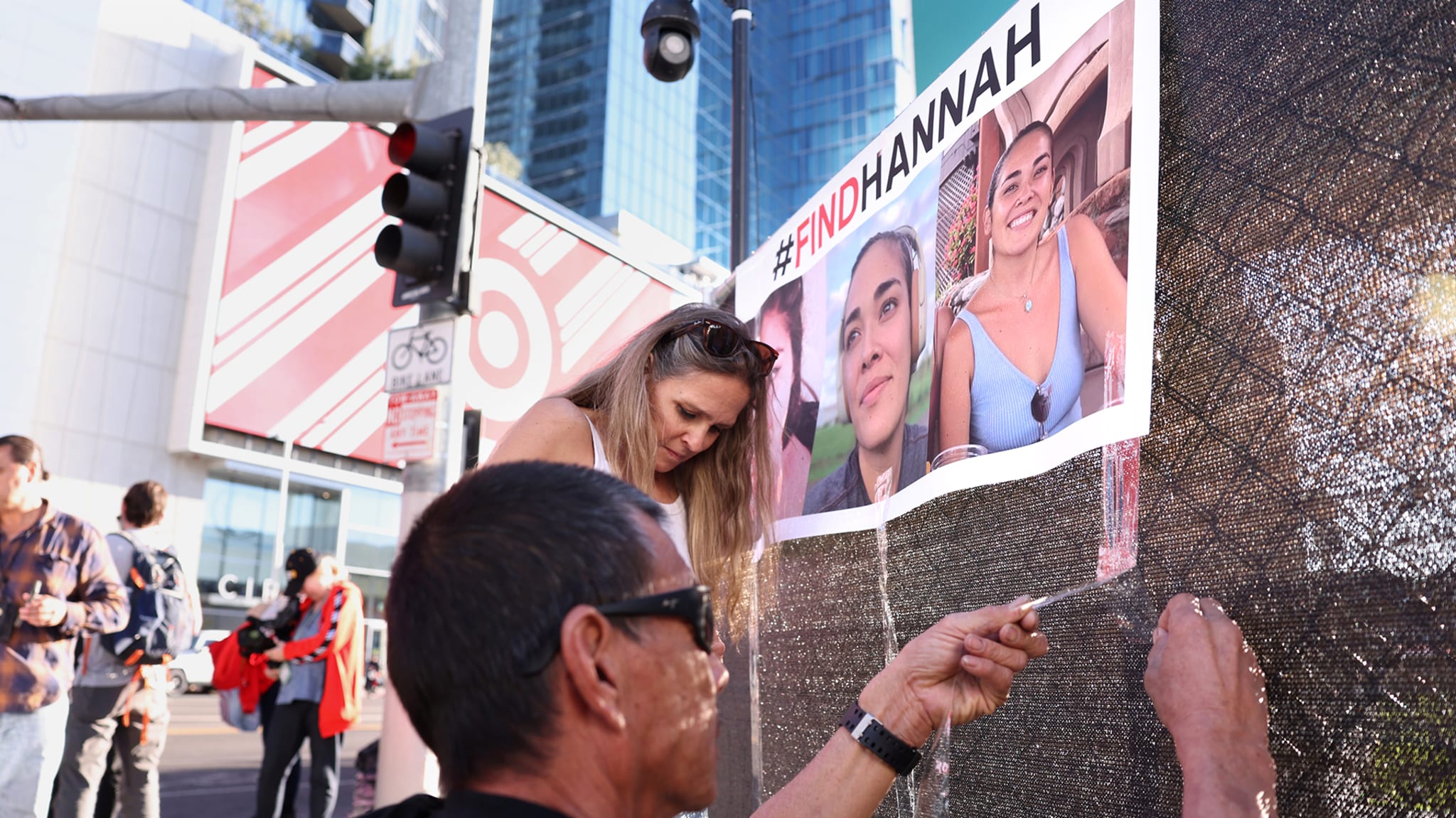 Volunteers put up flyers of missing Maui woman Hannah Kobayashi.
