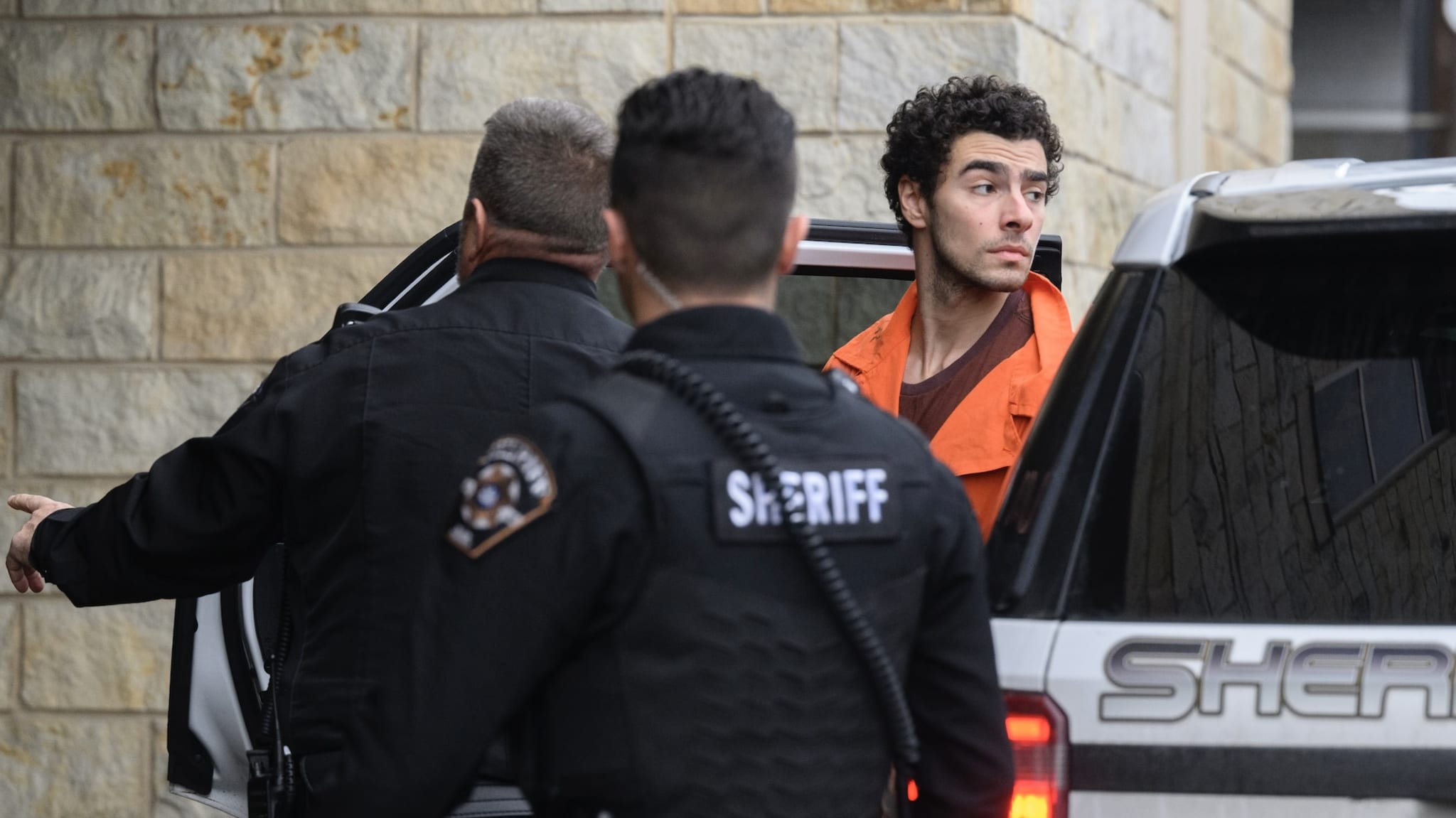 Suspected shooter Luigi Mangione is led into the Blair County Courthouse