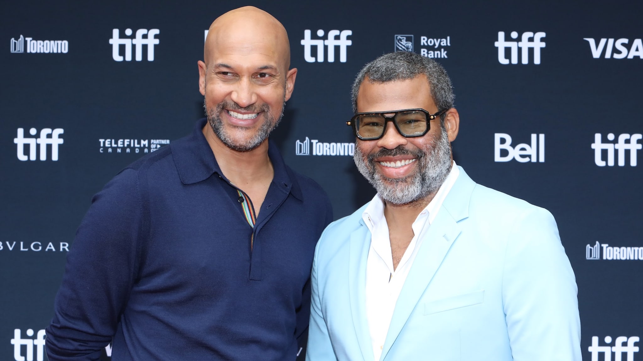 Keegan-Michael Key and Jordan Peele smiling at the TIFF event, standing in front of a branded backdrop.