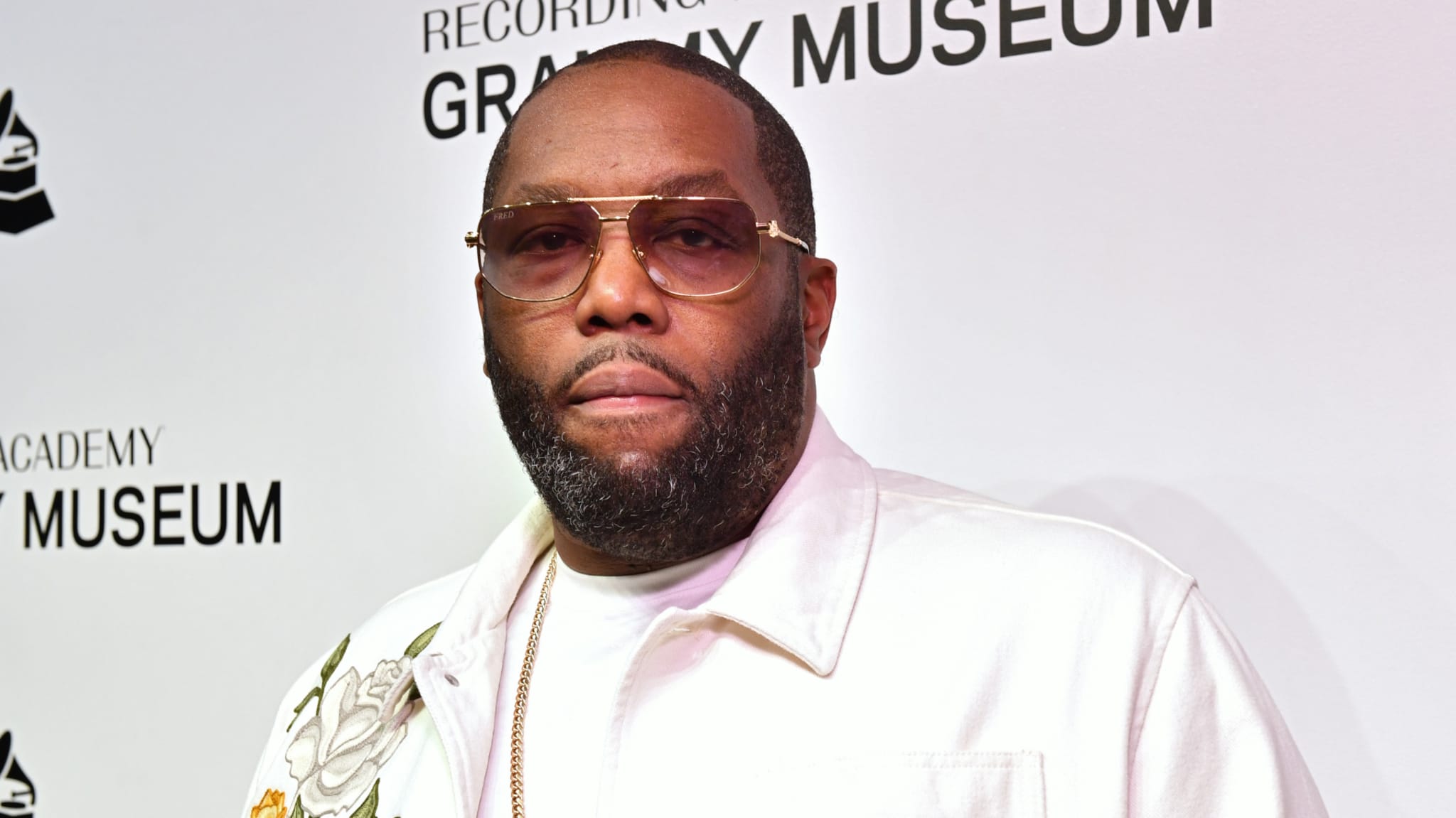 Killer Mike at a Grammy Museum event, wearing sunglasses and a white jacket.