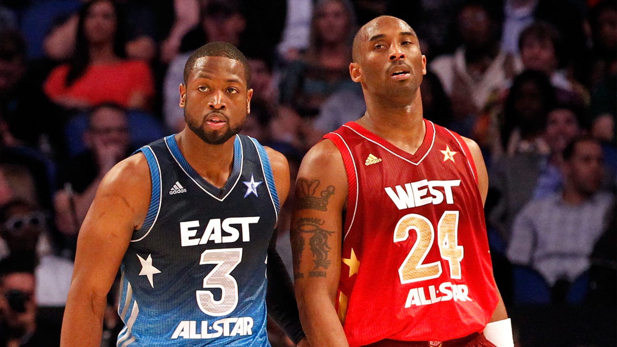 Dwyane Wade in a blue East All-Star jersey and Kobe Bryant in a red West All-Star jersey during an NBA All-Star game.