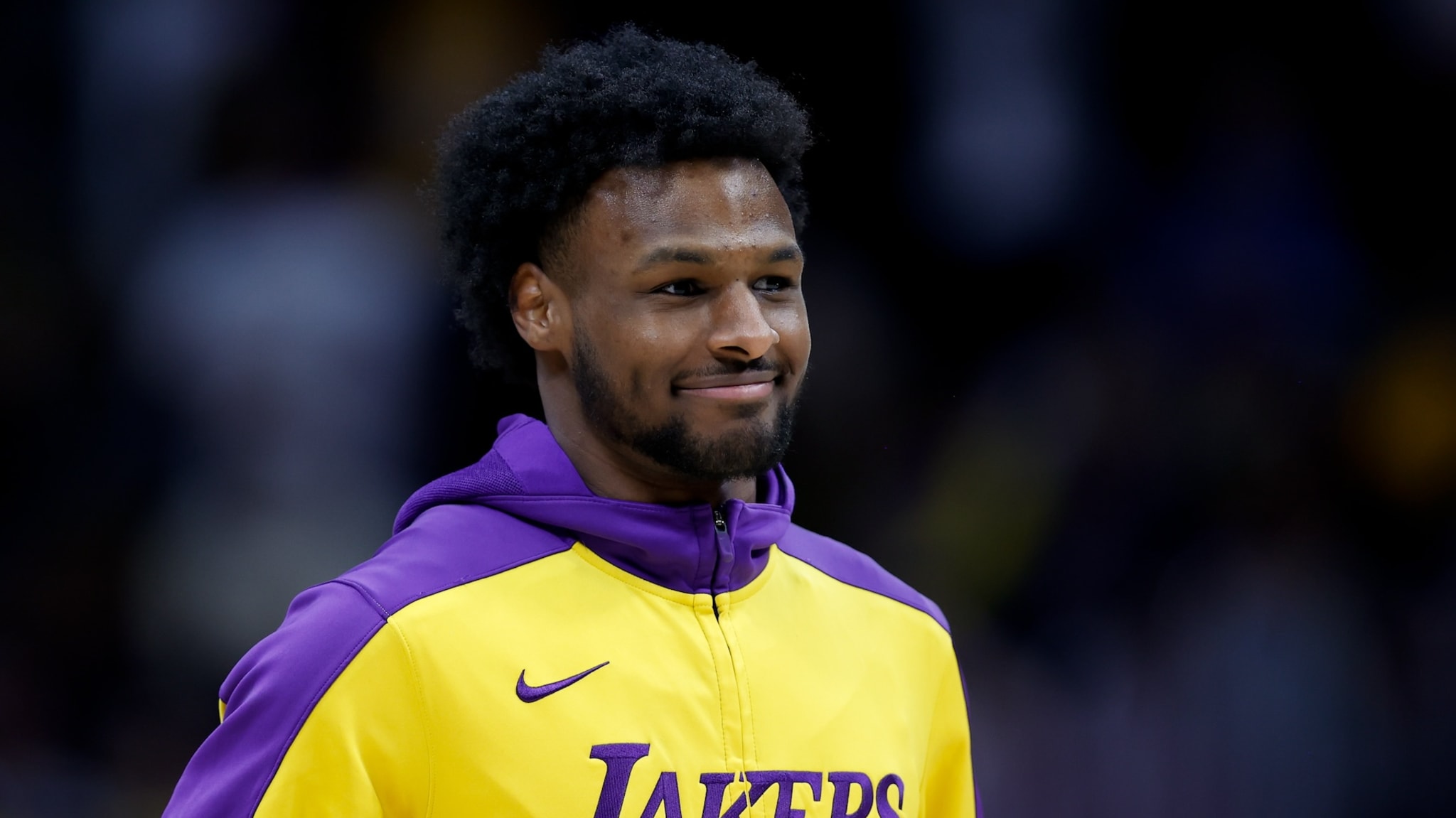 DENVER, CO - MARCH 14: Bronny James #9 of the Los Angeles Lakers smiles while warming up on the court before a game against the Denver Nuggets at Ball Arena on March 14, 2025 in Denver, Colorado.