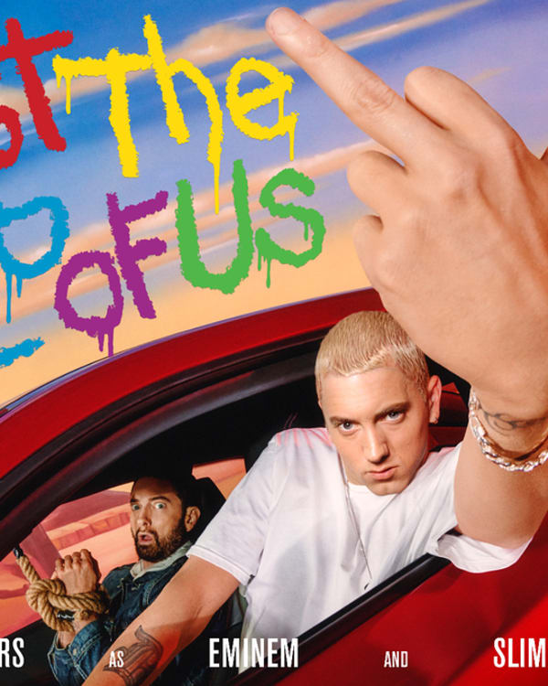Marshall Mathers, Eminem, and Slim Shady pose in a car with "Just the Two of Us" graffiti in the background. Eminem shows his middle finger