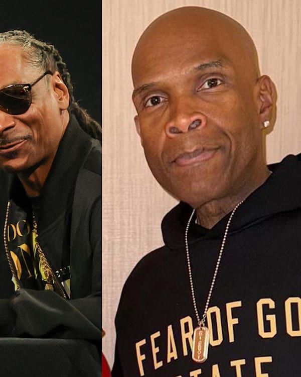Dr. Dre and Snoop Dogg speaking at a panel, both wearing black jackets. Big Boy in a "Fear of God" hoodie is on the right.