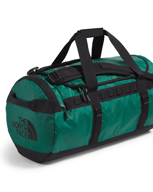 Green and black The North Face duffel bag with straps and logo.