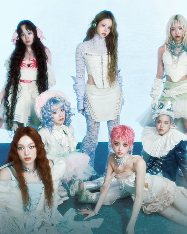 Seven members of XG pose in elaborate outfits for "The Core" album pop-up event in Los Angeles, presented by Complex.