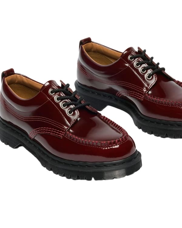 Shiny burgundy leather shoes with black laces and thick black soles, displayed on a white background.