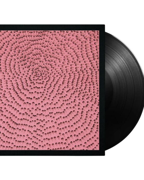 A vinyl record with a pink cover featuring a pattern of spiraling, abstract shapes.
