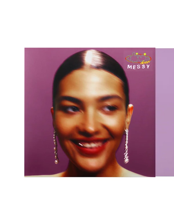 Album cover with a smiling woman on a purple background, titled "Messy." A black vinyl record is partially visible.