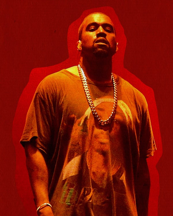 Kanye West standing against a red background, wearing a graphic t-shirt and a chain necklace. This was Kanye during the Life of Pablo era in 2016. 
