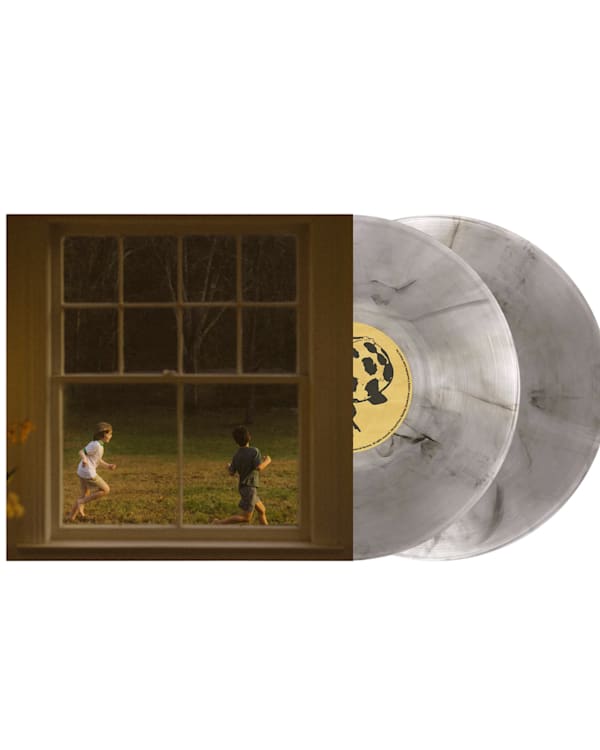 A vinyl record set with a cover showing two children playing outside, viewed through a window. The records are a marbled gray color.