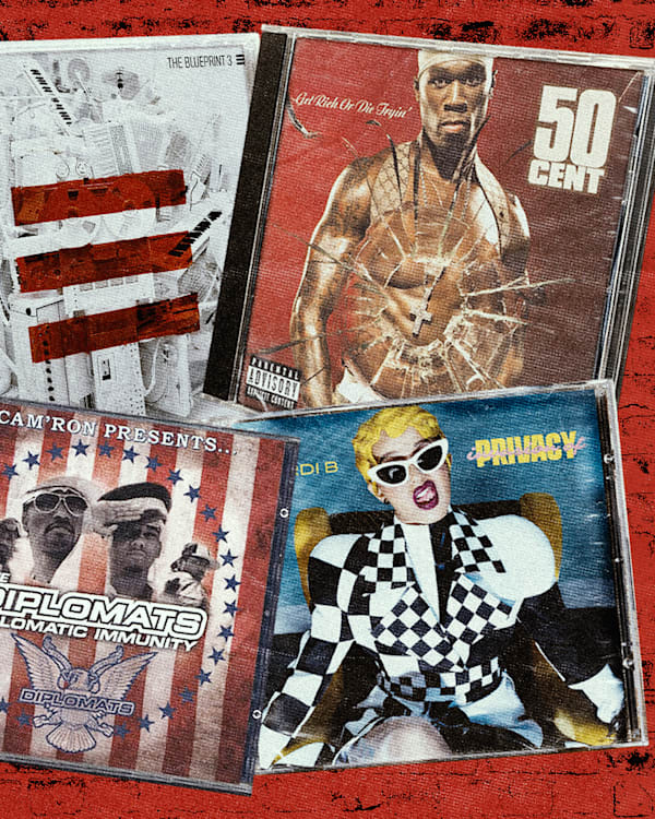 Four album covers on a red brick background: Jay-Z's "The Blueprint 3," 50 Cent's "Get Rich or Die Tryin'," The Diplomats' "Diplomatic Immunity," and Cardi B's "Invasion of Privacy." The albums feature some of the greatest New York City rap songs of all time. 