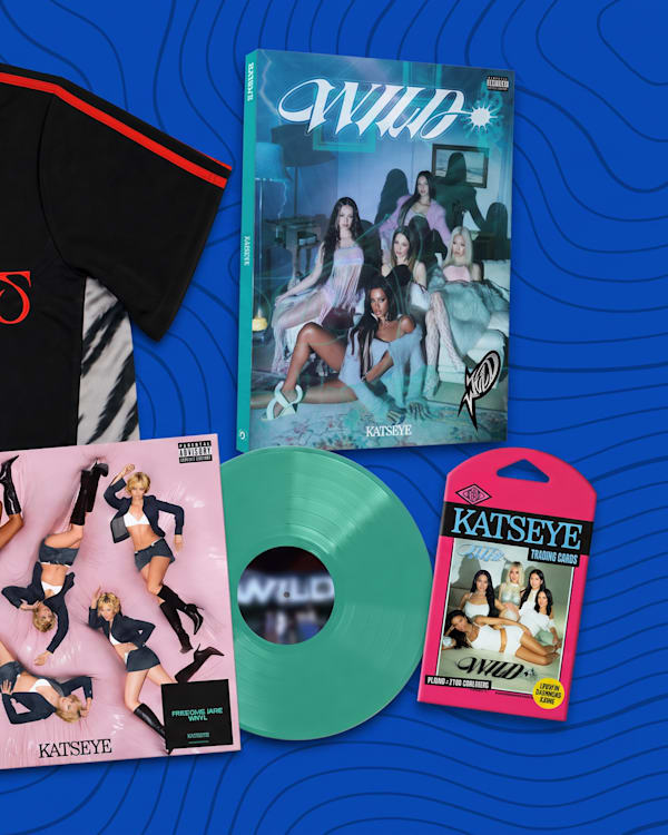 A collection of merchandise including a "Beautiful Chaos" jersey, vinyl records, a keychain, and posters with a blue background.
