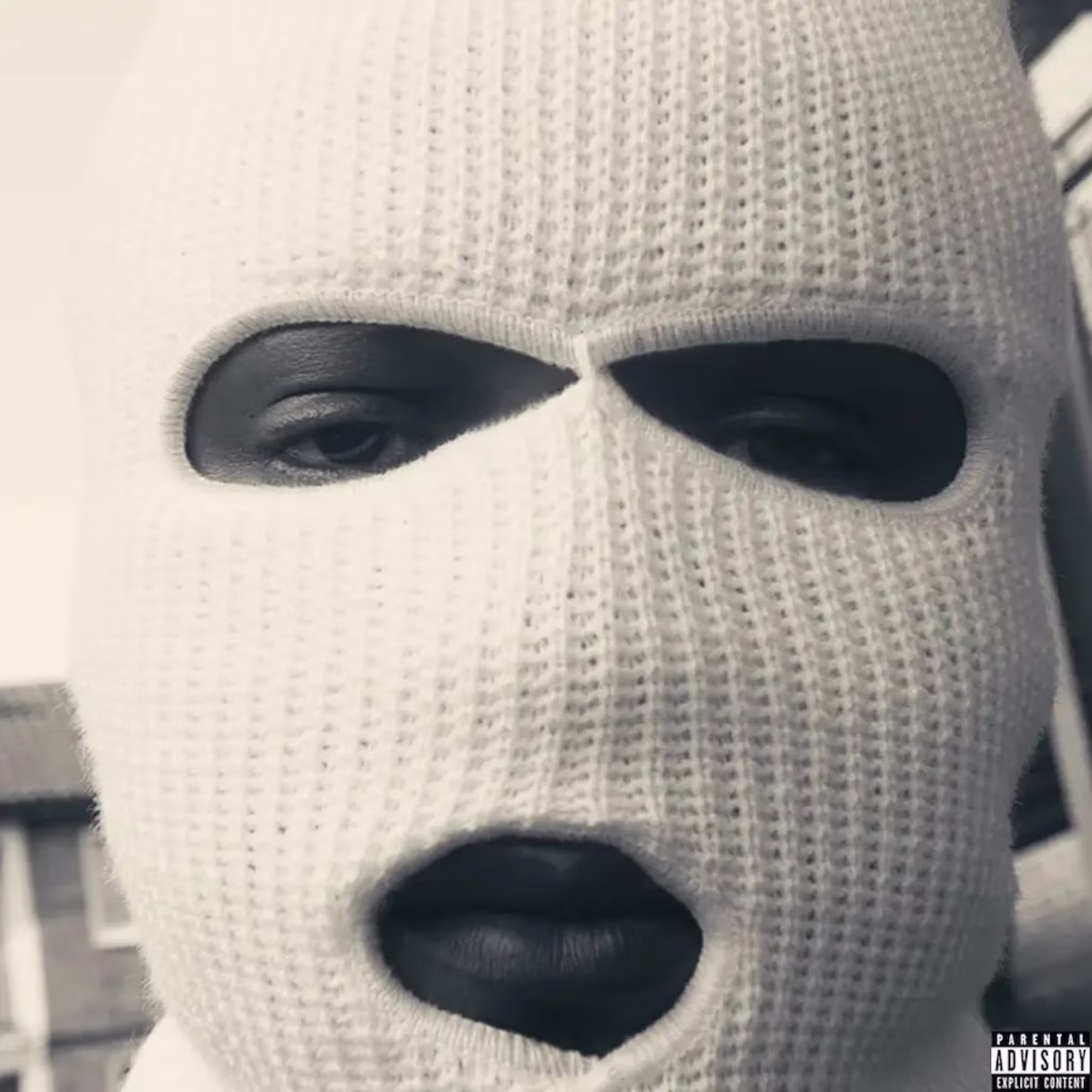 Close-up of a person wearing a knitted mask with eye and mouth openings