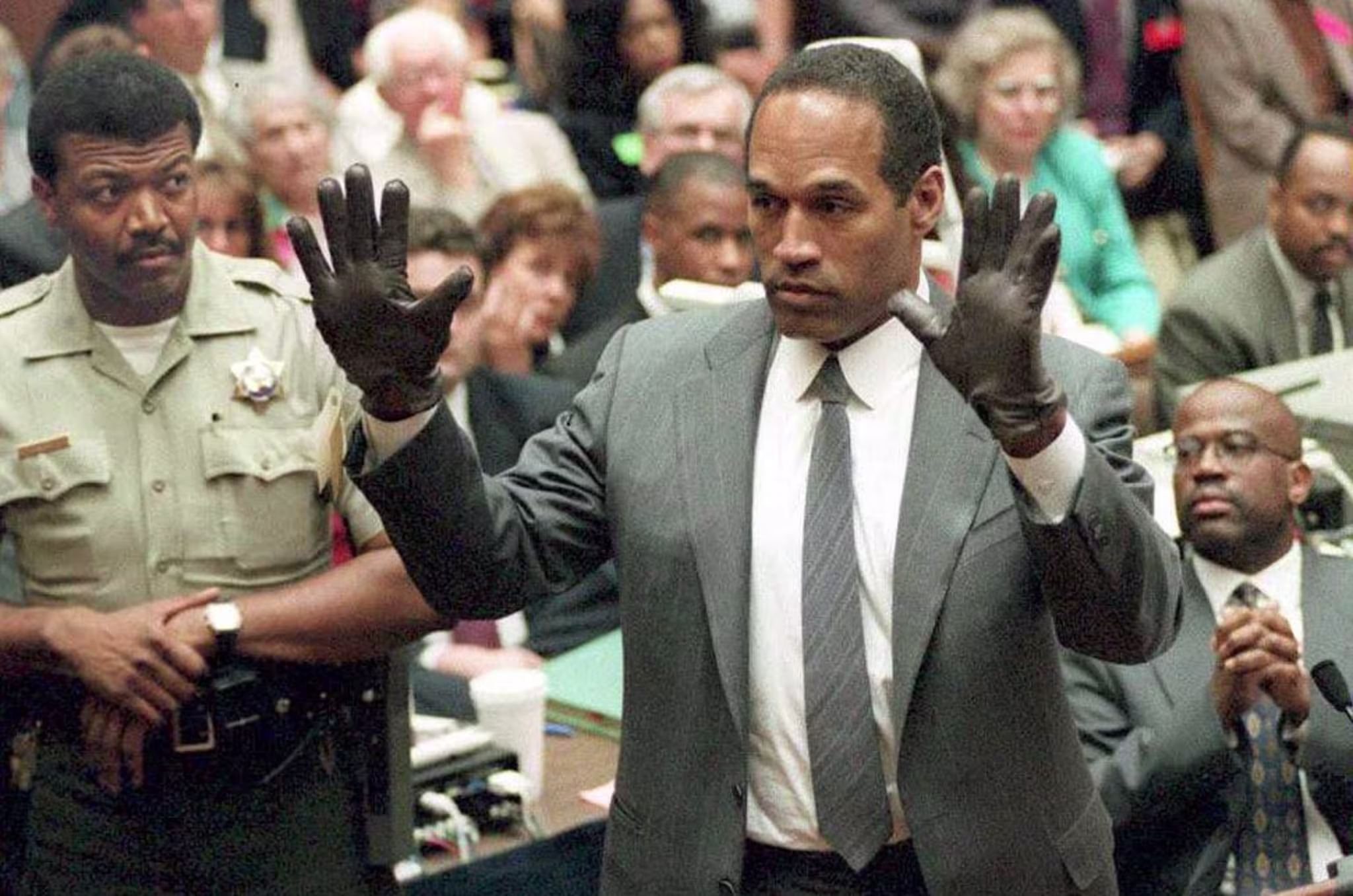 O.J. Simpson shows the jury a new pair of Aris ext