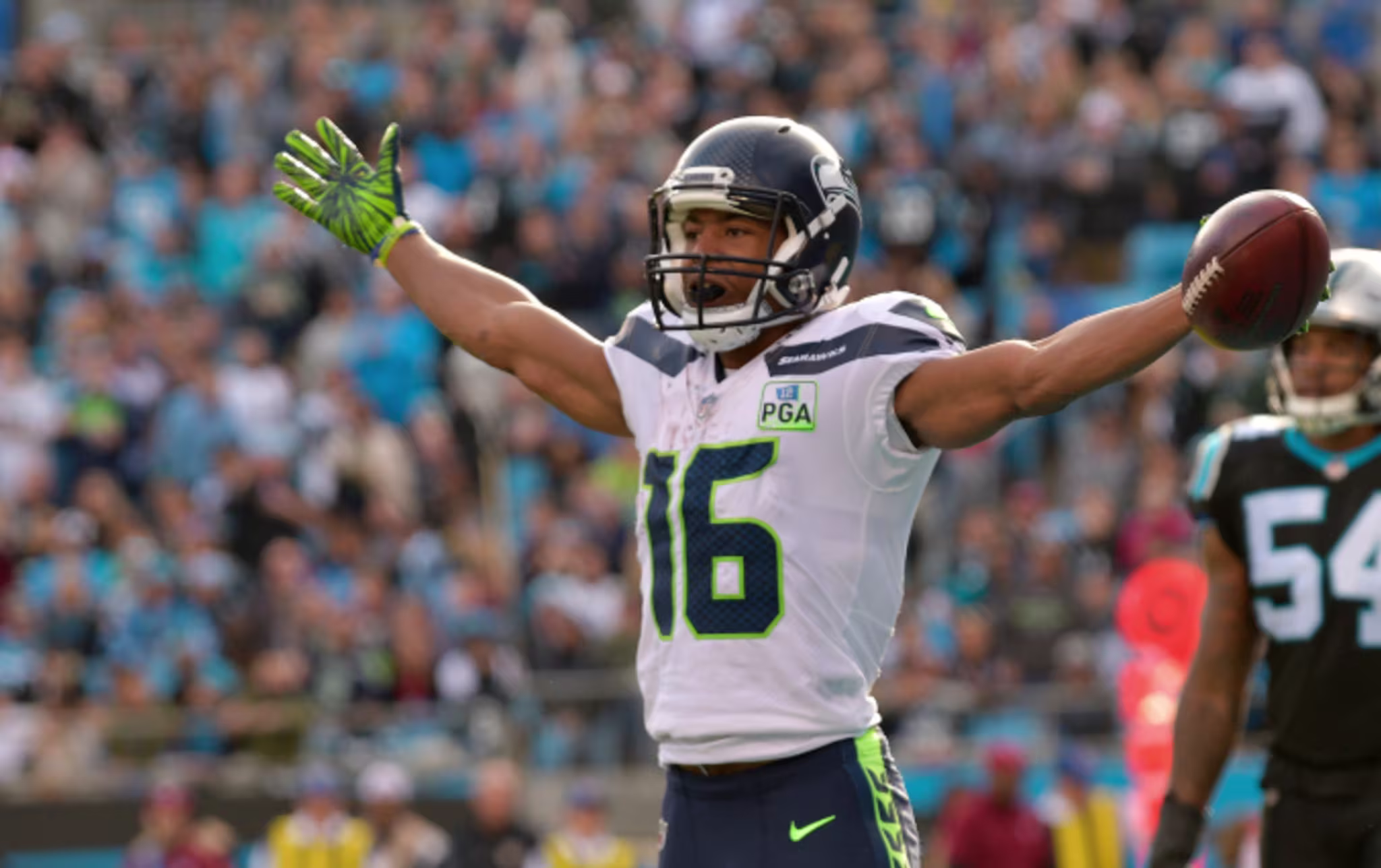Tyler Lockett #16 of the Seattle Seahawks celebrates a touchdown against the Carolina Panthers
