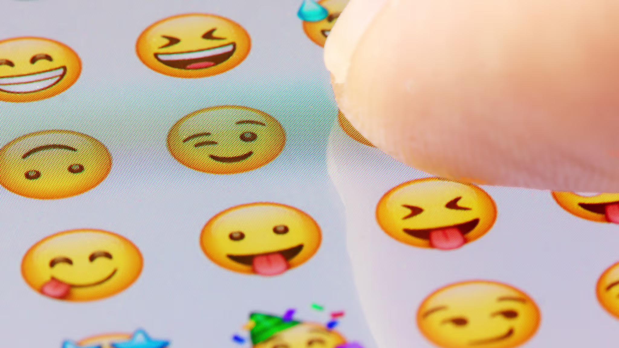 A stock photo of a person browsing through a list of emojis.
