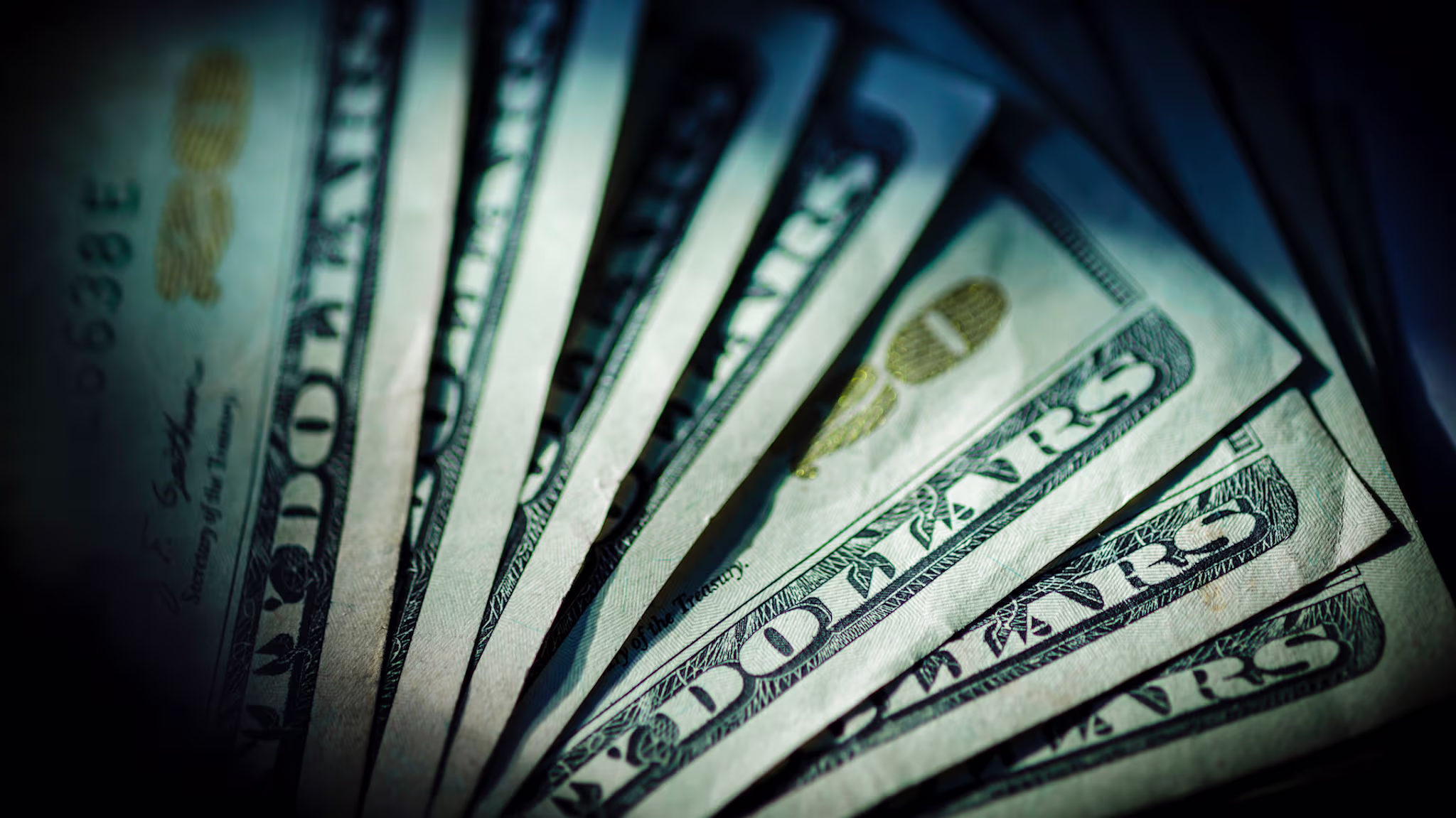 In this Photo Illustration Dollar bills lying on a table.