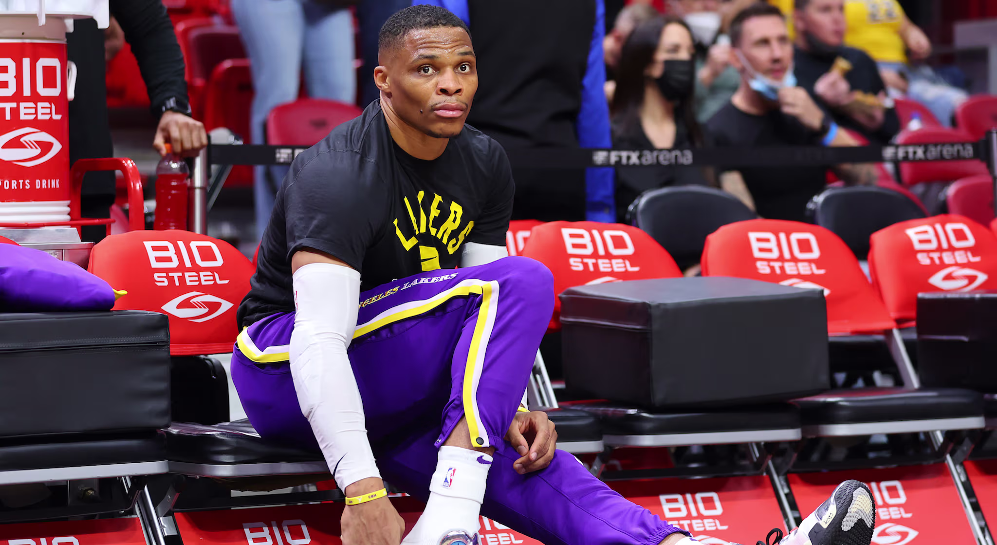 Russell Westbrook #0 of the Los Angeles Lakers laces up his shoes.