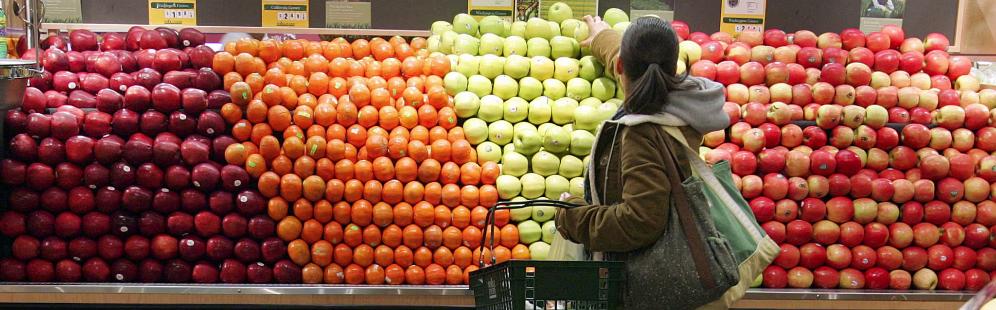 Person in the fruit aisle at grocery store