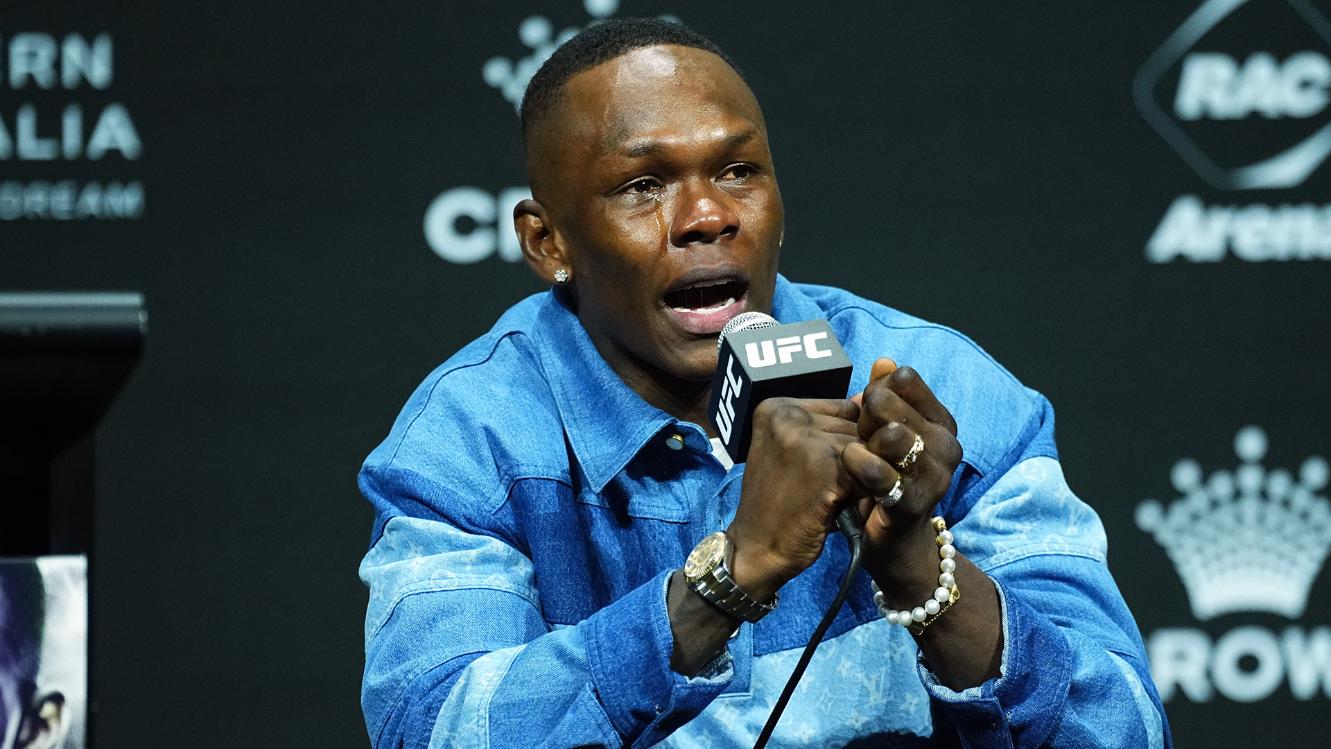 Israel Adesanya on stage during the UFC 305 press conference.