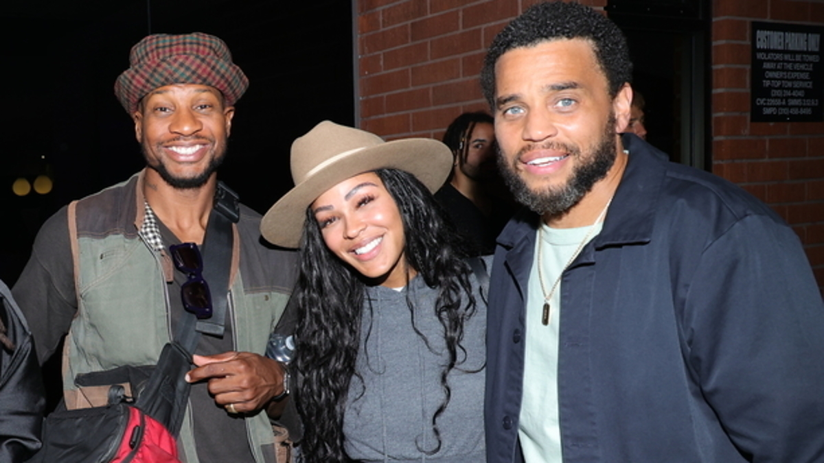 Group photo of five people, all smiling and standing closely together