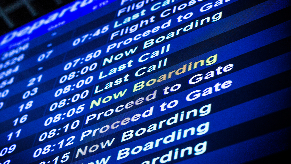 Airport departures board showing various flights: Now Boarding for several flights, along with other statuses like Last Call, Proceed to Gate, and Flight Closed