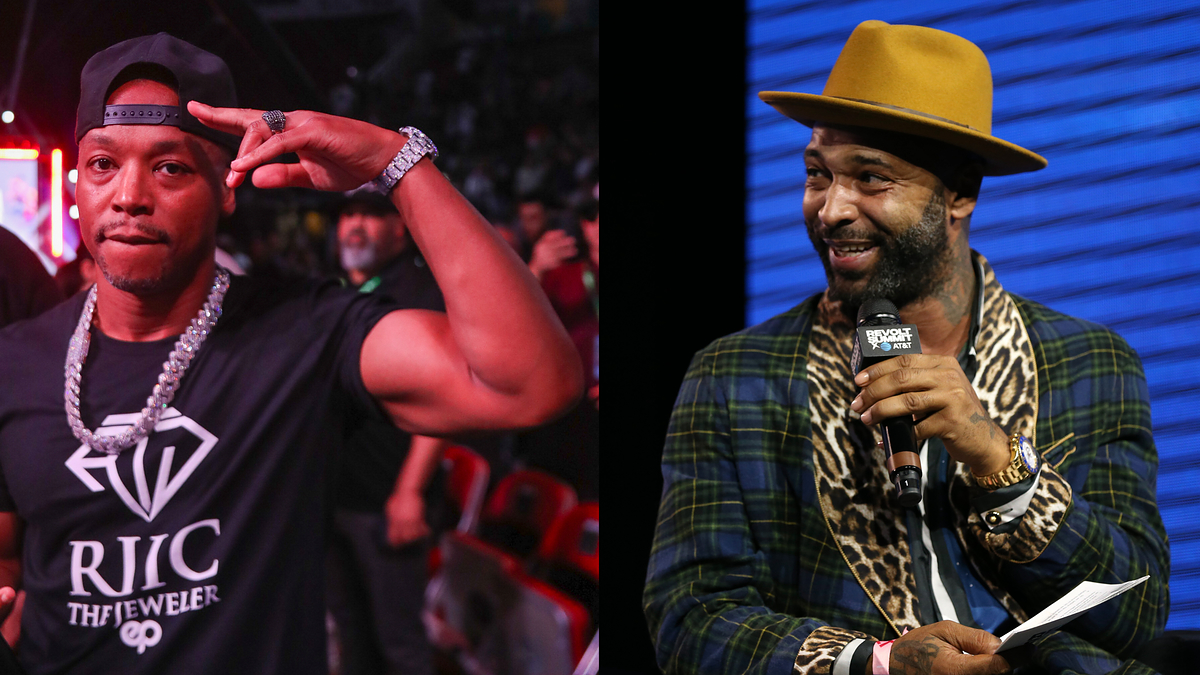 Rapper Papoose makes a peace sign while wearing an RJIC The Jeweler shirt. Joe Budden speaks into a microphone on stage in a plaid shirt and tan hat