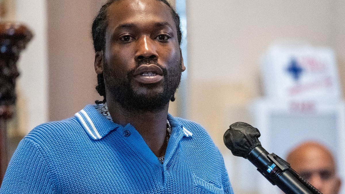 Meek Mill speaks into a microphone during a public appearance