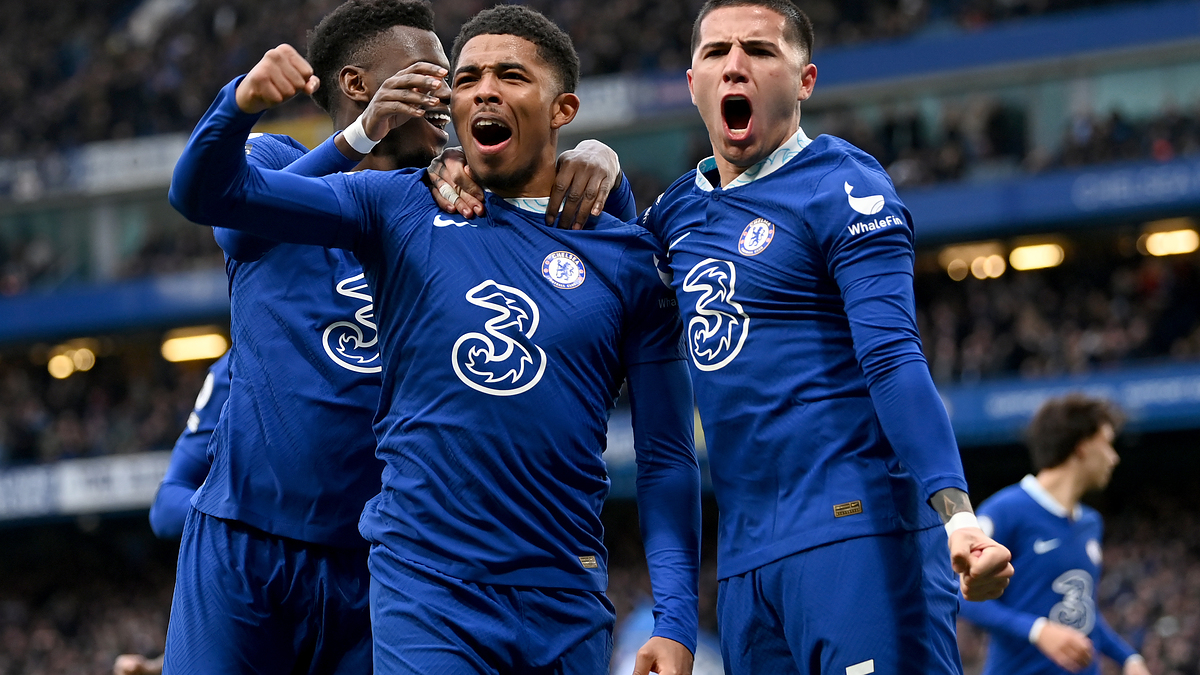 Wesley Fofana, Mason Mount, and teammates celebrate a goal while wearing blue Chelsea FC jerseys during a football match