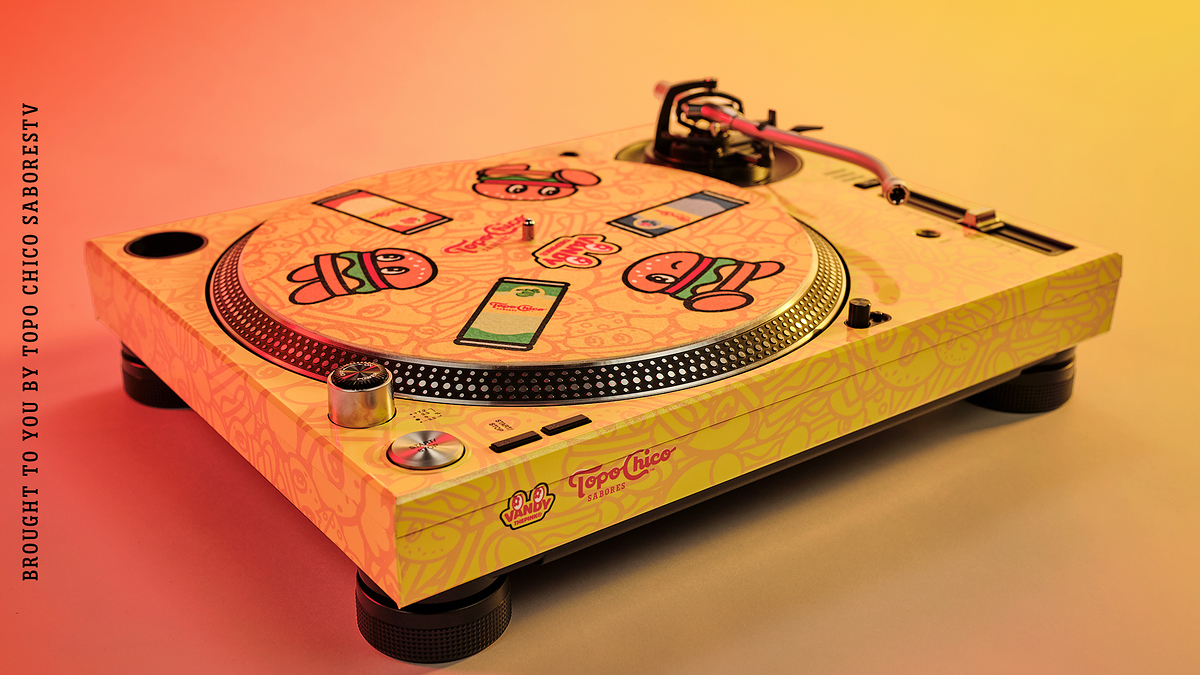 Limited edition turntable design by Topo Chico and Vandy the Pink, featuring playful illustrated vinyl record covers and a colorful base. Text header: "Limited Edition Turntable"
