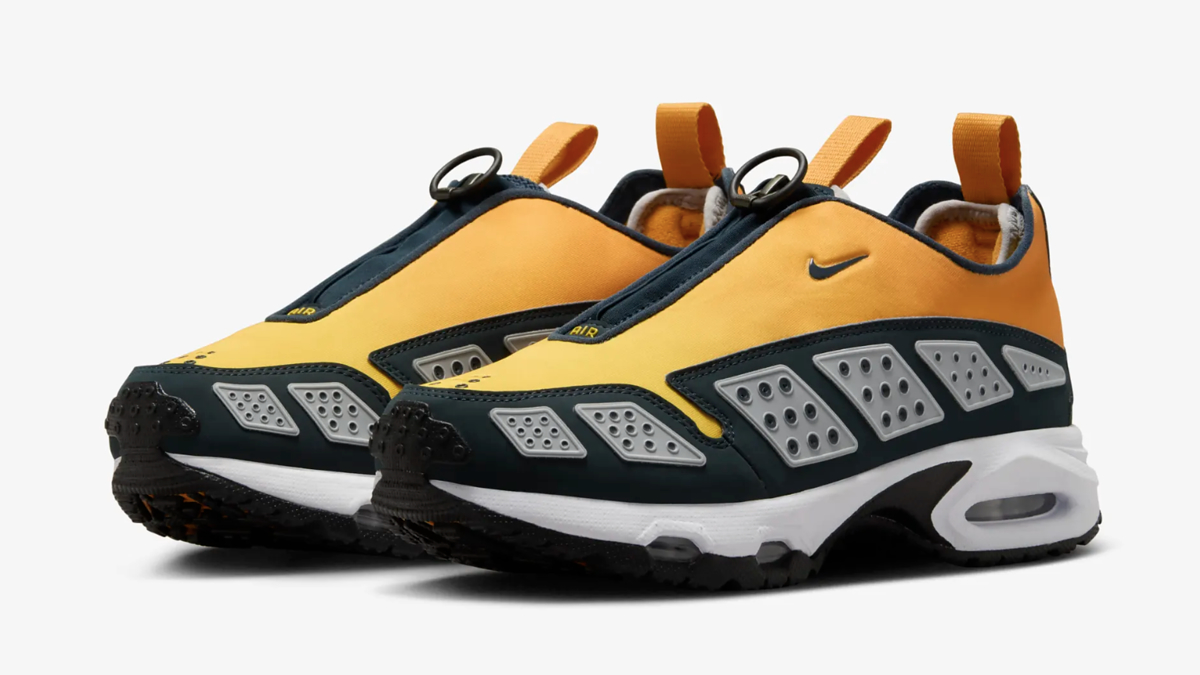 A pair of Nike Air Mada sneakers. The shoes feature a sleek design with breathable panels, a pull tab, and distinctive circular lace loops