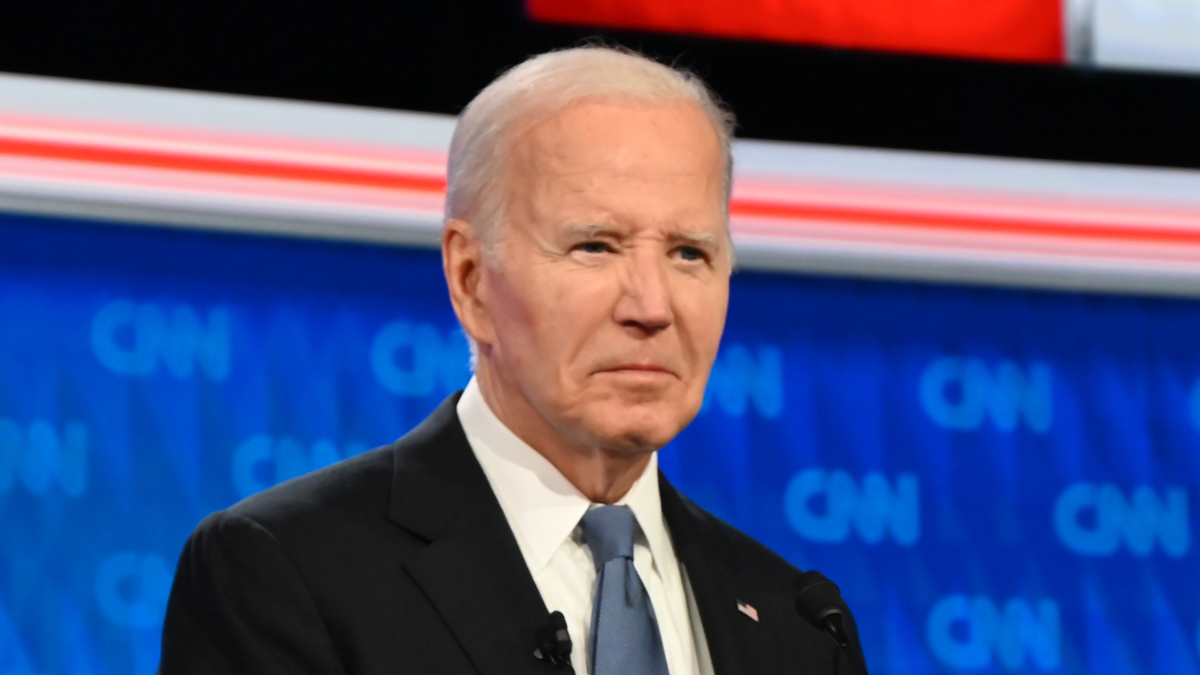 Joe Biden, wearing a dark suit and tie, appears on a CNN stage during a media event
