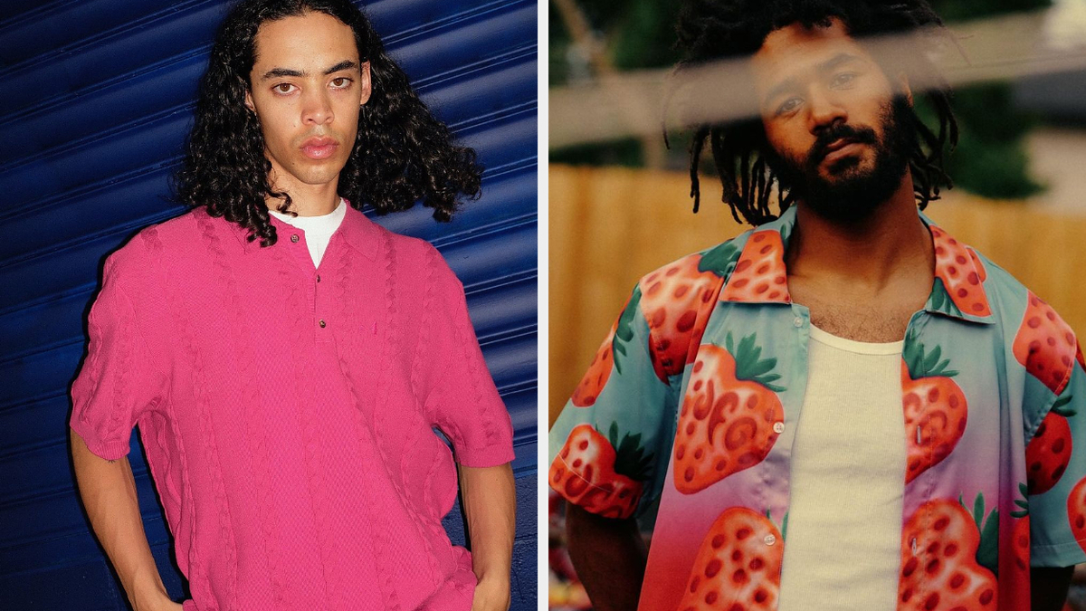 Two men posed side by side. The man on the left wears a knit shirt, while the man on the right wears a strawberry-patterned shirt with a white tank top