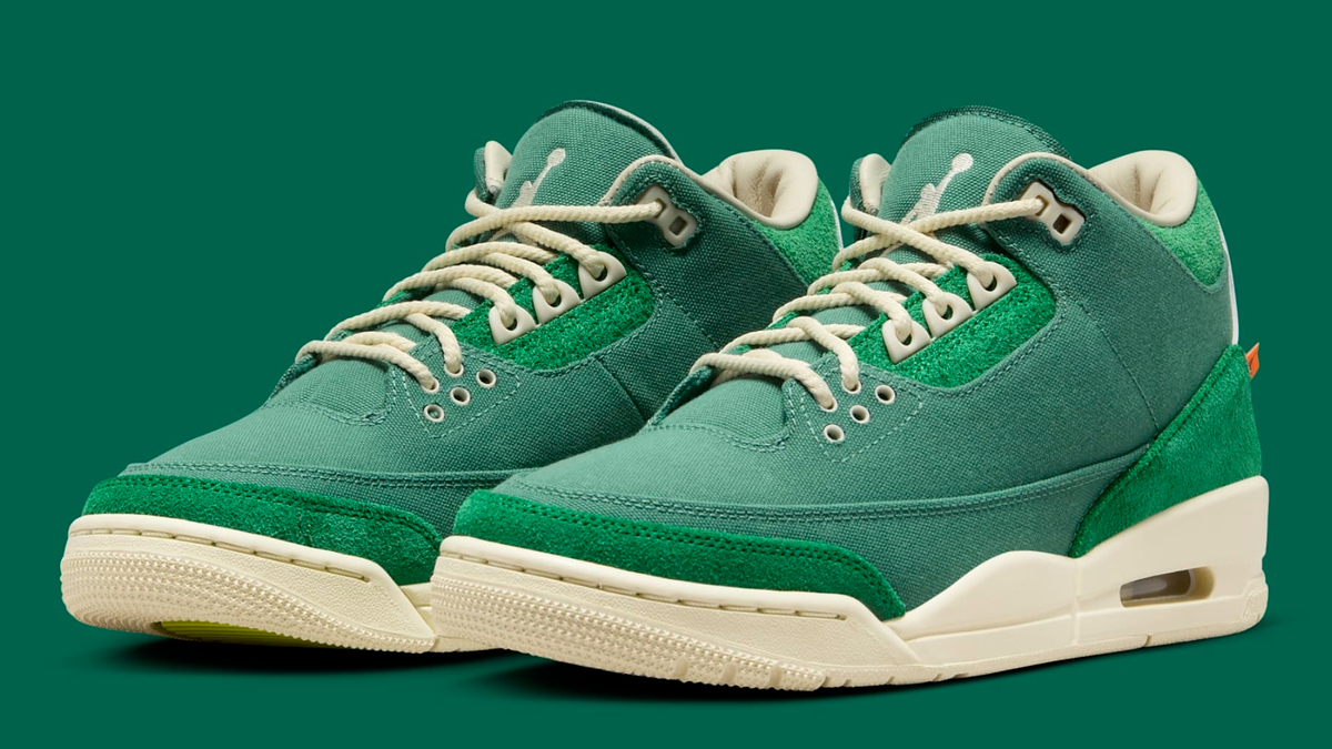 Pair of green sneakers with white soles and laces, displayed on a green background. They feature a mix of suede and leather materials