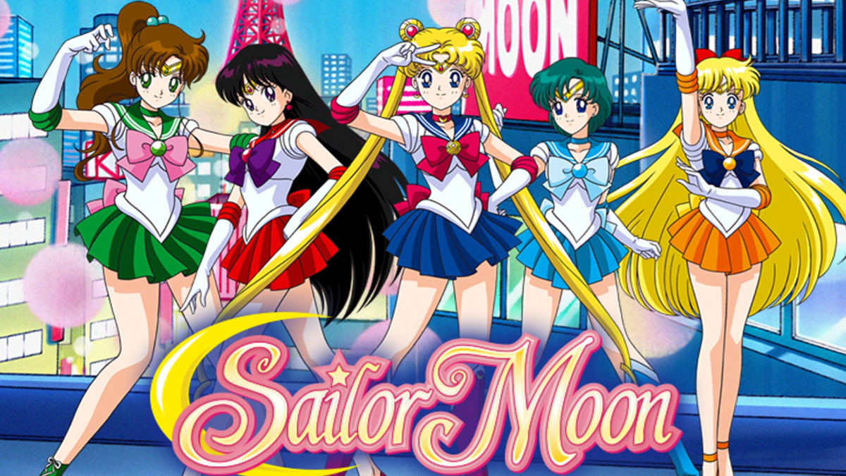 Sailor Moon characters: Sailor Jupiter, Sailor Mars, Sailor Moon, Sailor Mercury, and Sailor Venus. They are in their iconic sailor outfits, posing together
