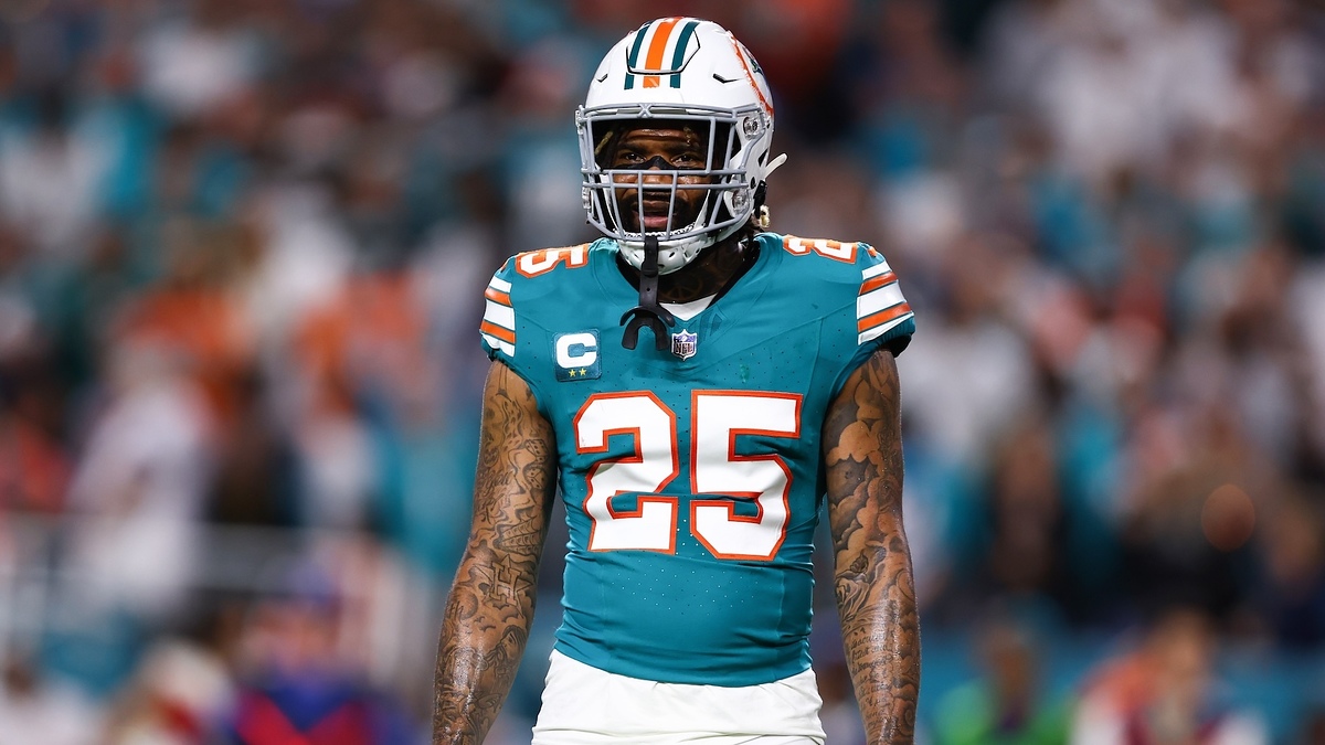 Xavien Howard, wearing a football uniform and helmet, stands on a field during a game