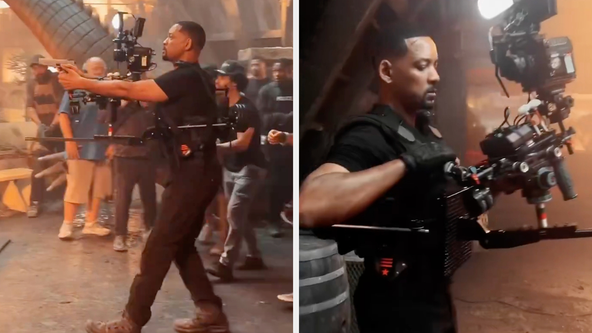 Will Smith operating a professional camera on a movie set, surrounded by crew members