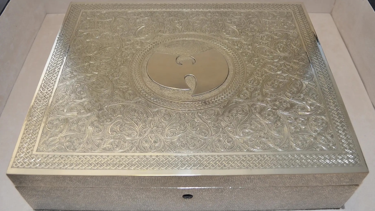 An intricately designed metal box featuring the Wu-Tang Clan's logo on its lid