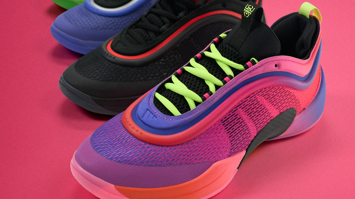Four pairs of stylish sneakers with a modern design are arranged in a row on a solid background, showcasing various vibrant color schemes