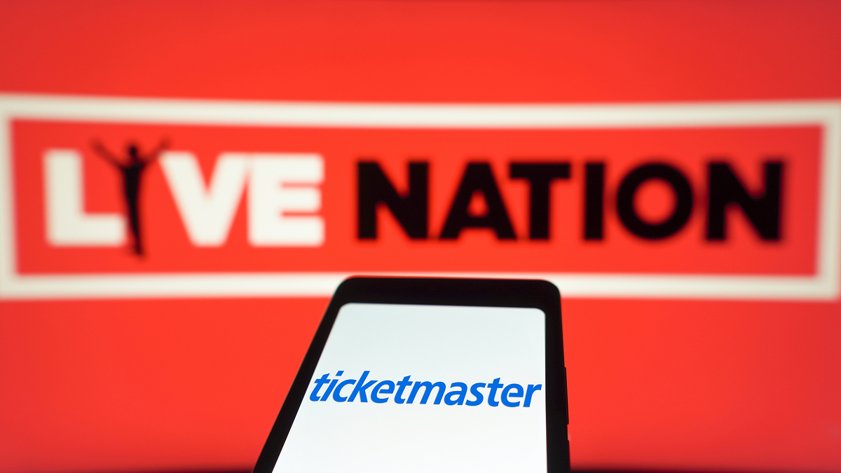 Live Nation logo in the background with a smartphone displaying the Ticketmaster logo in the foreground