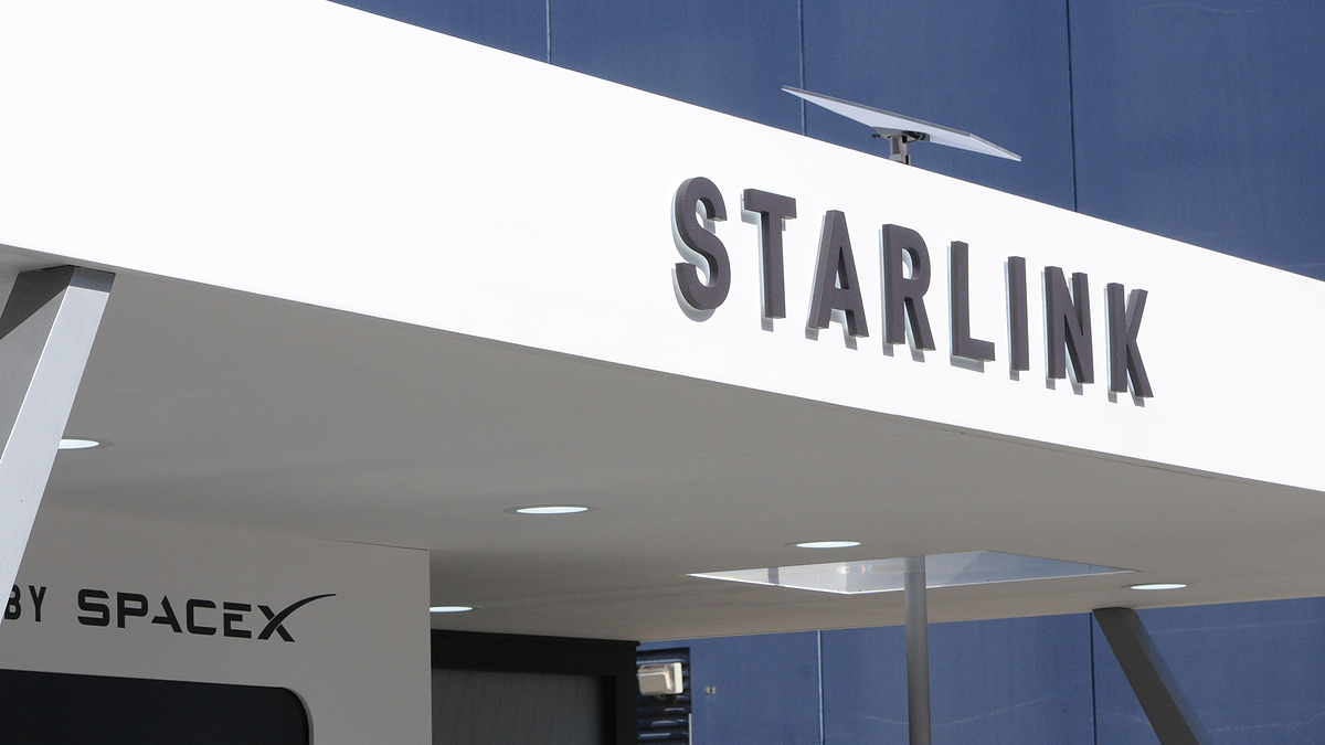 Signage of a Starlink building with the company's logo prominently displayed. "By SpaceX" is written on the lower left part of the structure