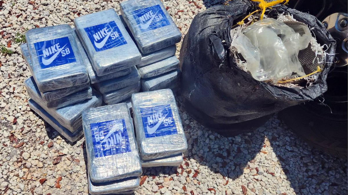 Seventeen packages labeled "Nike SB" stacked beside a black bag with spillage. Image related to sneakers category