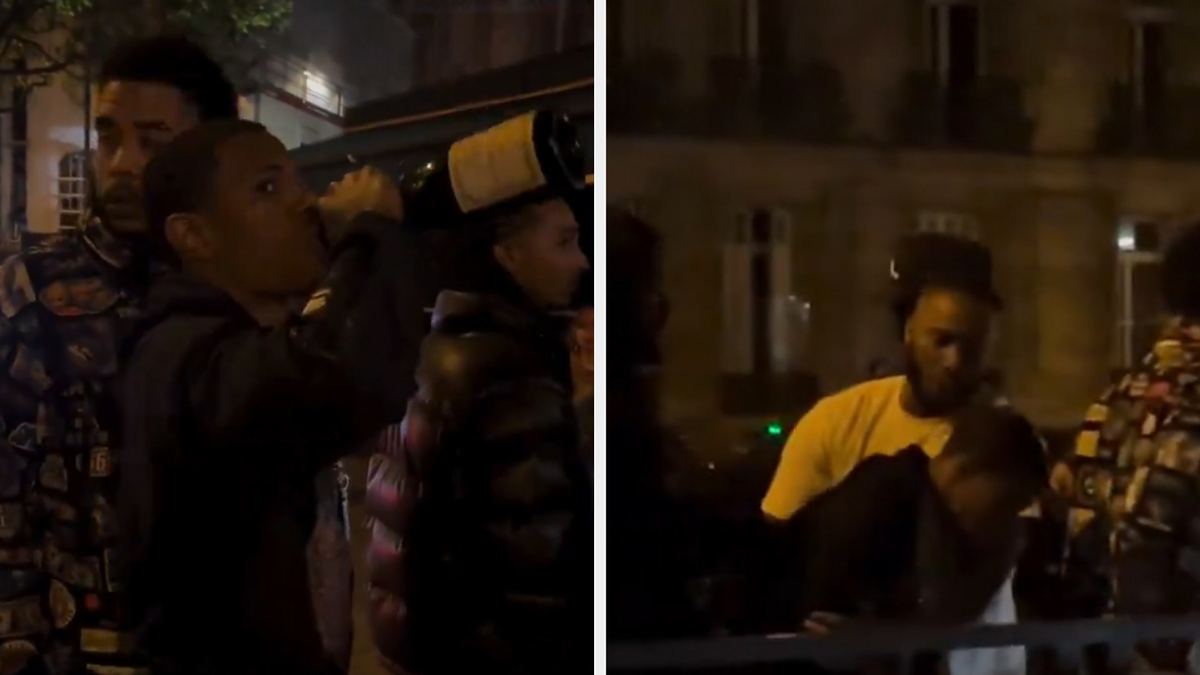 Four individuals outside at night, two looking upwards, one drinking from a bottle, one sitting with head down