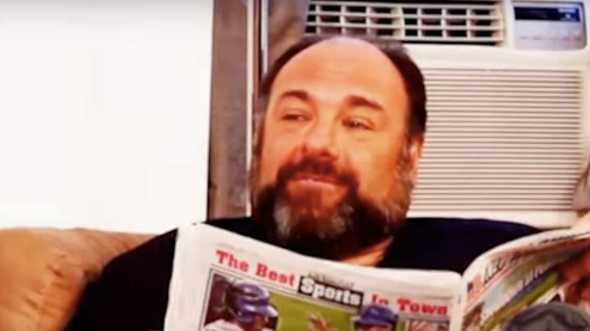 Gandolfini reading a newspaper titled "The Best Sports in Town"