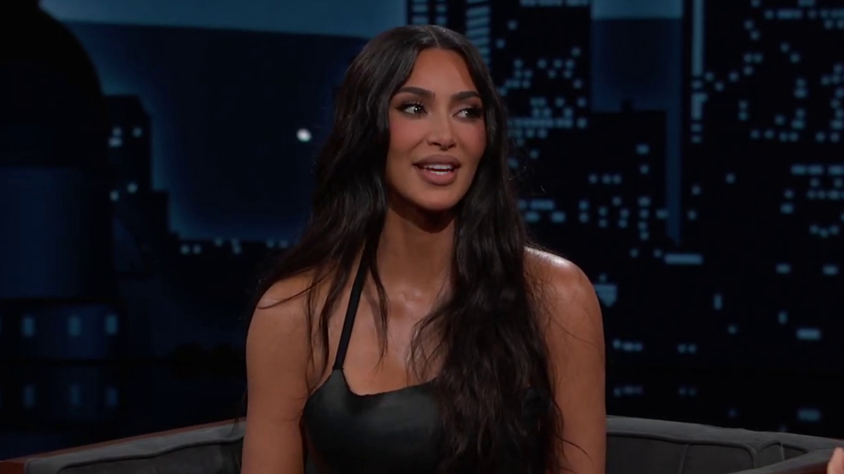 Kim Kardashian in a black top on a talk show set
