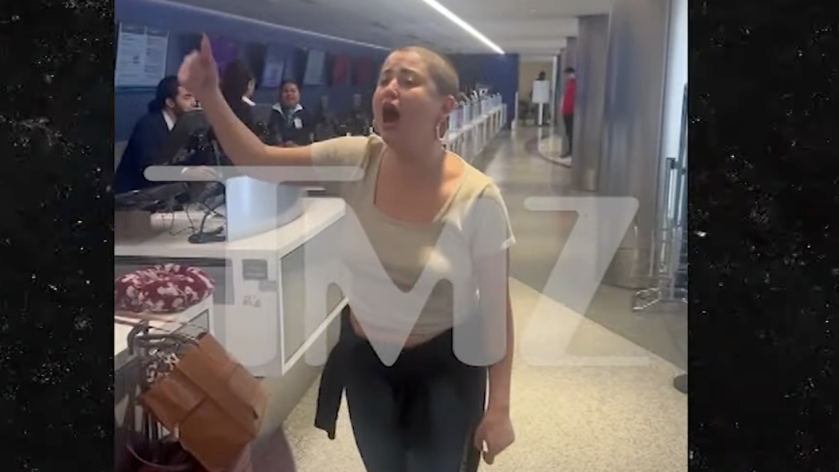 Woman gesturing passionately in a public indoor setting