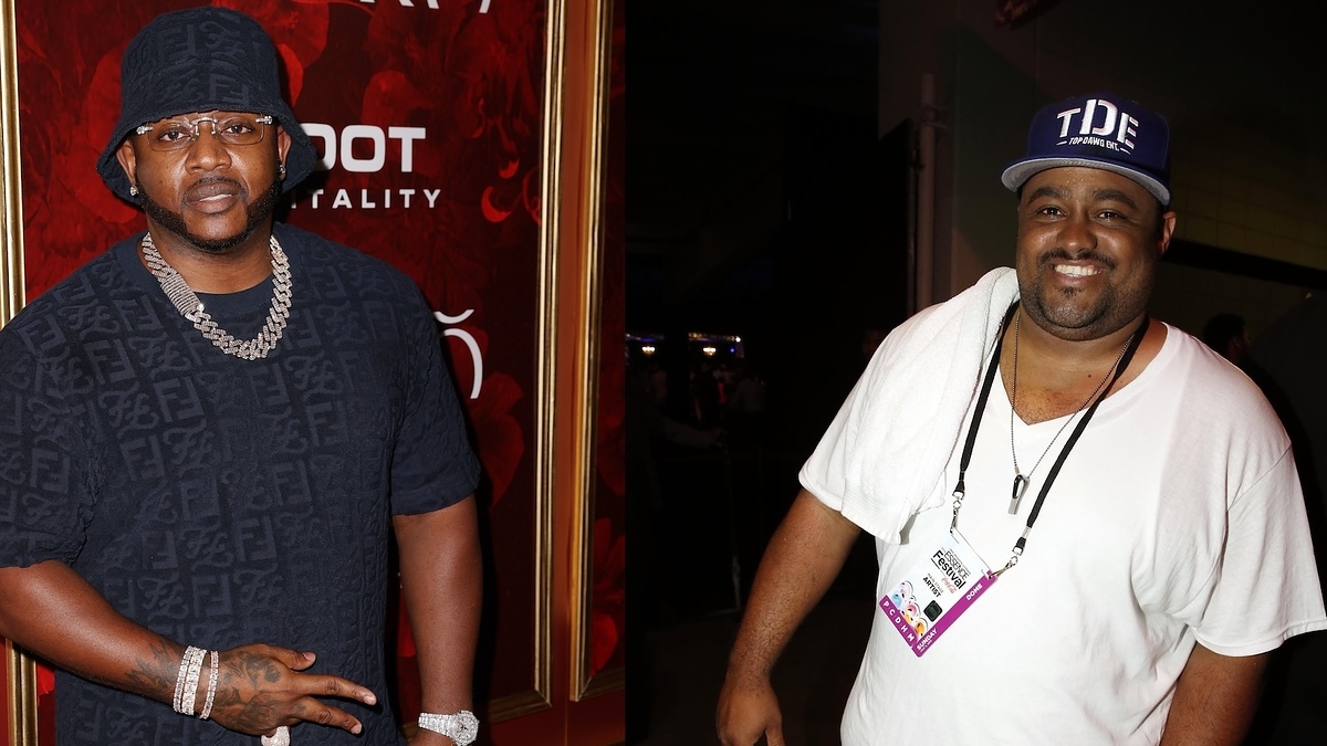 Two men at an event, left wearing a black durag and chain, right in a white tee and blue cap