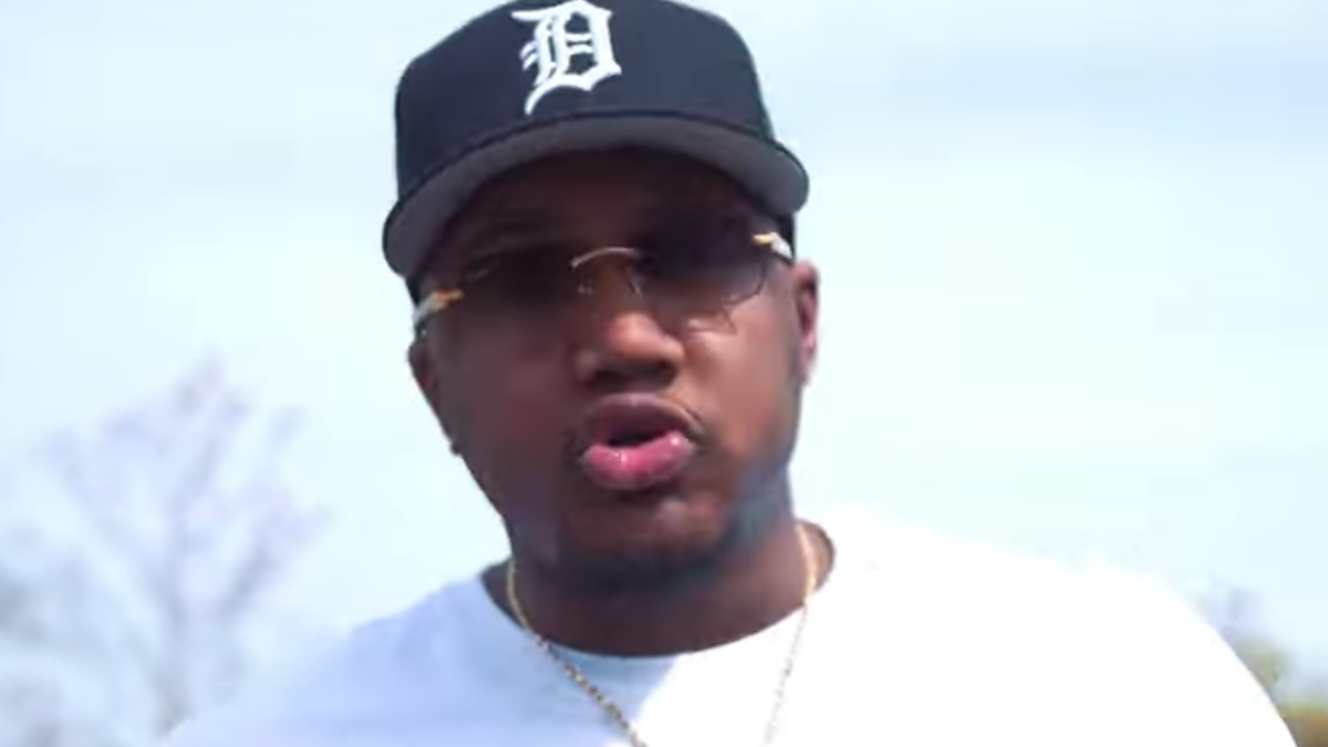 Man wearing a cap and sunglasses outdoors