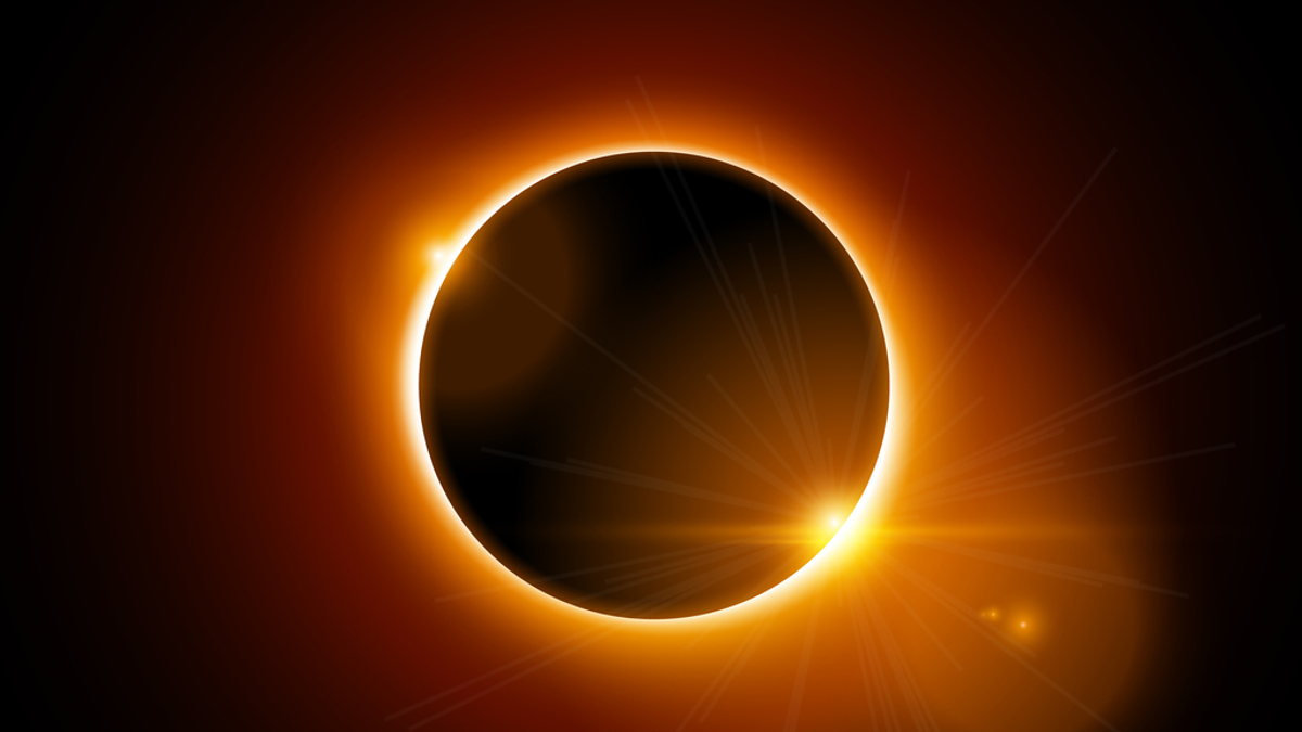 Solar eclipse with bright corona visible and starburst effect to one side